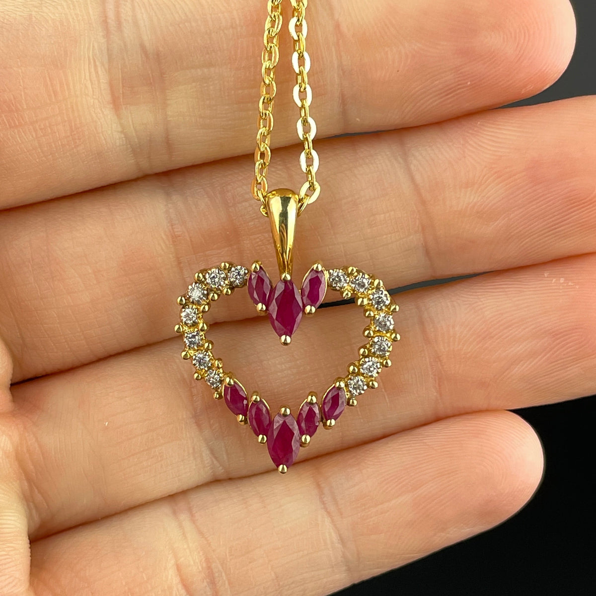 Solid gold heart pendant with genuine diamonds and good Marquise rubies