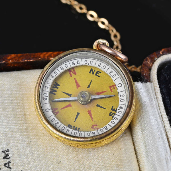 Golden pendant with compass motif