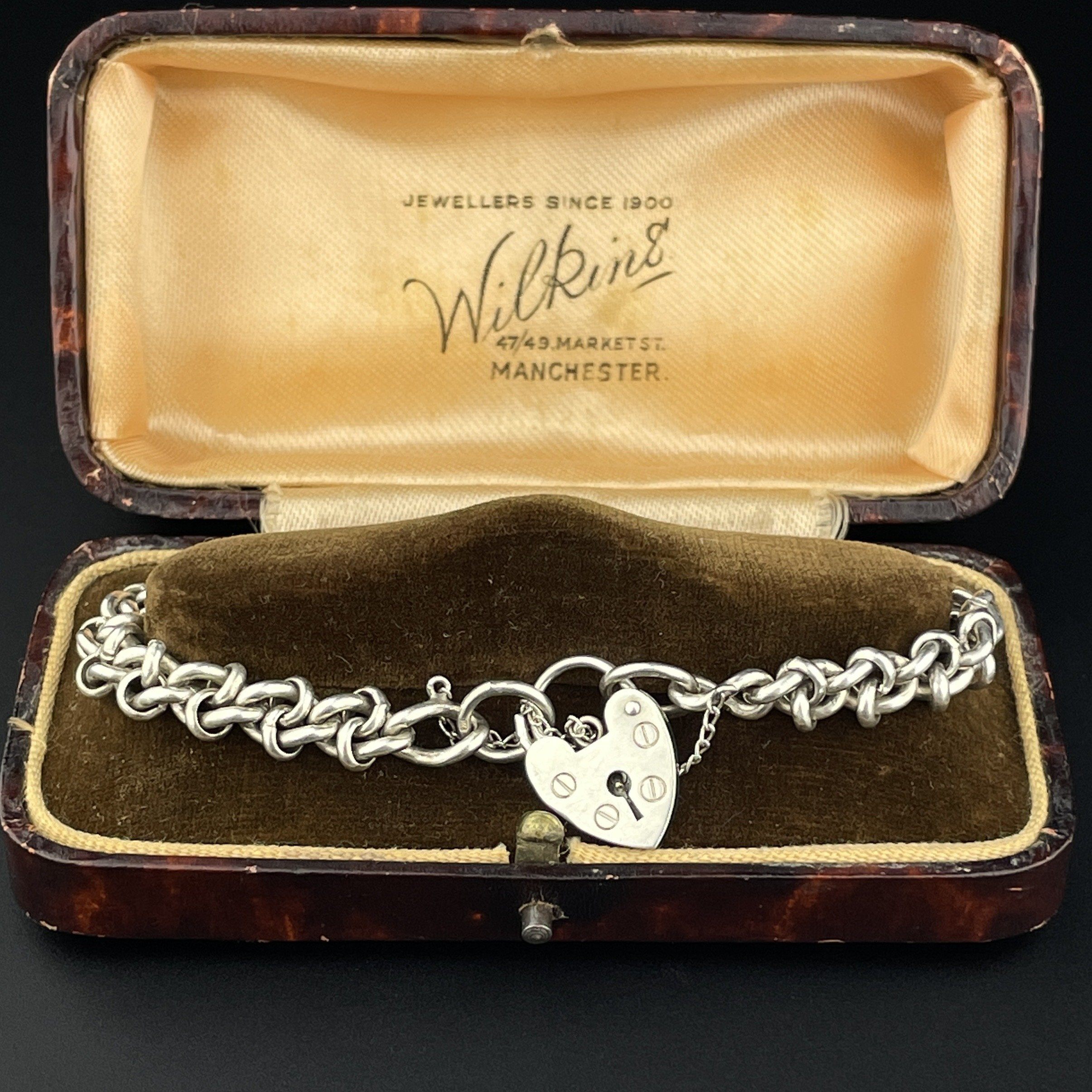 A sterling silver solid heavy curb link charm bracelet with 18 charms and padlock heart clasp 2024 70.81 grams